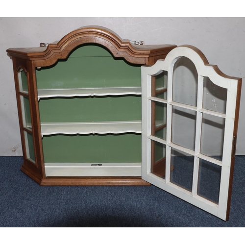 728 - A walnut hanging cabinet with arched top, astragal glazed door flanked by glass sides enclosing shap... 