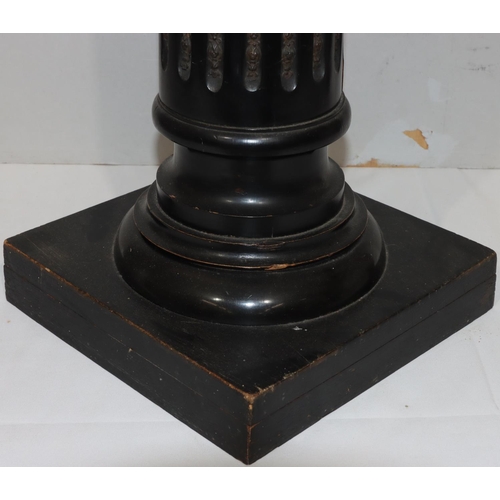 729 - An ebonised square topped torchiere on Corinthian column support with fluted decoration and raised g... 