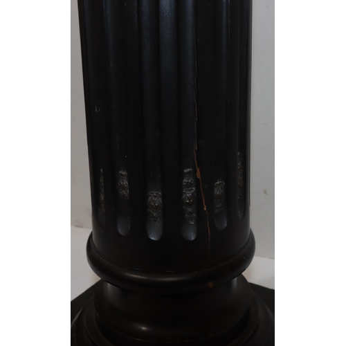 729 - An ebonised square topped torchiere on Corinthian column support with fluted decoration and raised g... 