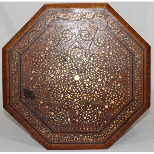 731 - An Eastern octagonal shaped coffee table with brass and copper inlaid floral, leaf and scroll decora... 