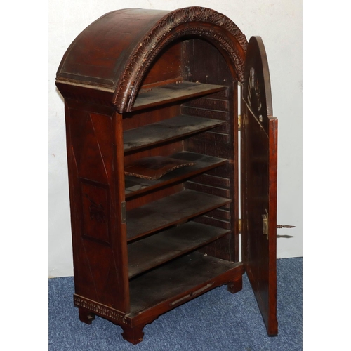 732 - An oak domed table topped cabinet, single panel door with raised carved and pierced figure, leaf and... 