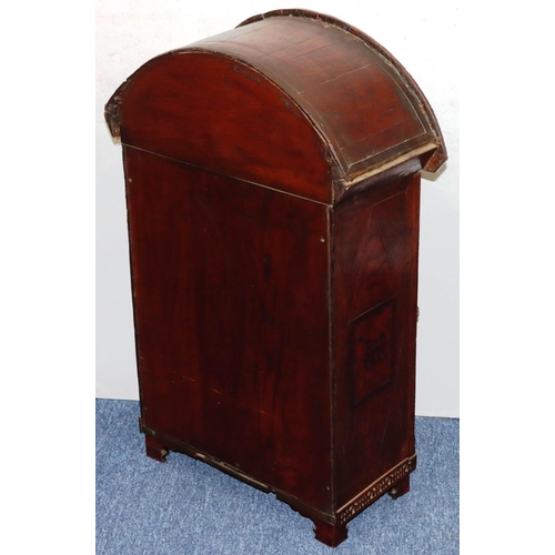 732 - An oak domed table topped cabinet, single panel door with raised carved and pierced figure, leaf and... 