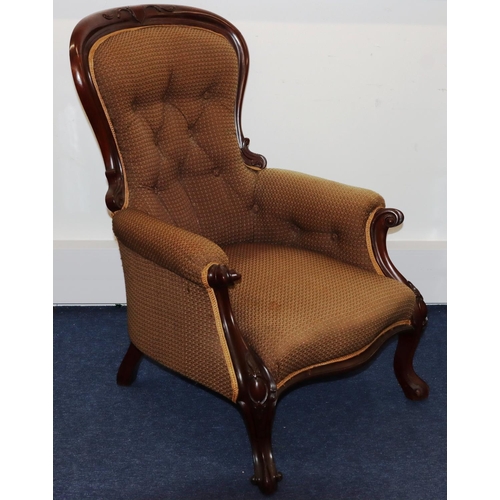 736 - A Victorian mahogany spoon back armchair with overstuffed seat, button back and padded arms, on spla... 