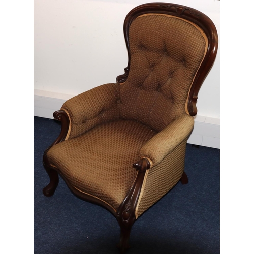 736 - A Victorian mahogany spoon back armchair with overstuffed seat, button back and padded arms, on spla... 