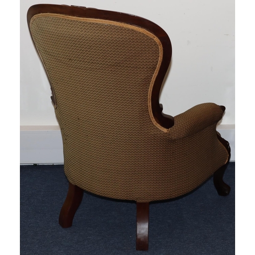 736 - A Victorian mahogany spoon back armchair with overstuffed seat, button back and padded arms, on spla... 