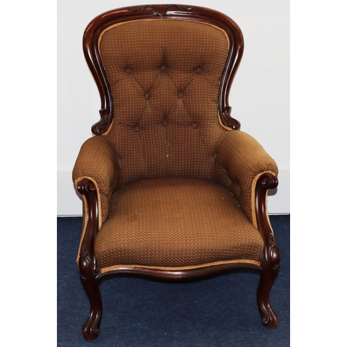 736 - A Victorian mahogany spoon back armchair with overstuffed seat, button back and padded arms, on spla... 