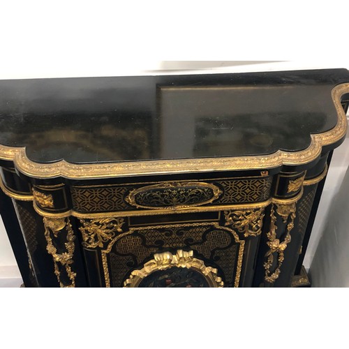 742 - A 19th Century ebonised and Ormolu Serpentine fronted side cabinet with allover raised floral, swag,... 