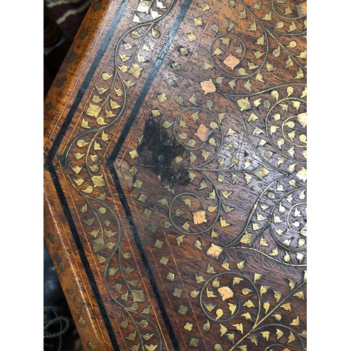 731 - An Eastern octagonal shaped coffee table with brass and copper inlaid floral, leaf and scroll decora... 