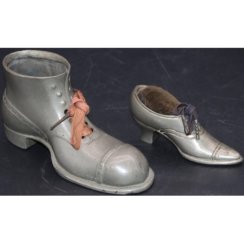 534 - A pewter pin cushion in the form of a lady's shoe, 9.5cm long and a larger pewter boot, 14.5cm long ... 