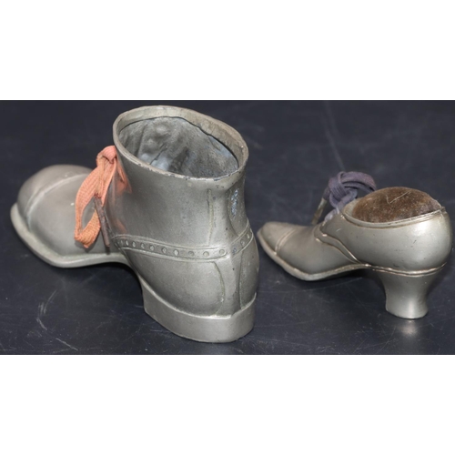 534 - A pewter pin cushion in the form of a lady's shoe, 9.5cm long and a larger pewter boot, 14.5cm long ... 