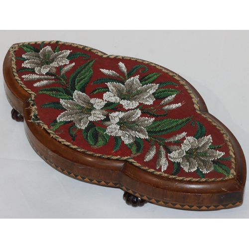 600 - A Victorian walnut scallop shaped table stand with bead word top and floral and leaf decoration, inl... 