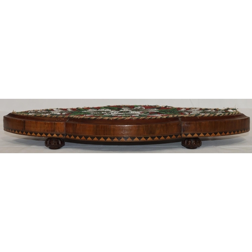 600 - A Victorian walnut scallop shaped table stand with bead word top and floral and leaf decoration, inl... 