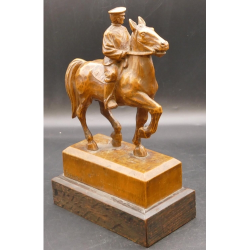 665 - A 19/20th Century carved wooden statue of a soldier on horseback, indistinctly signed and mounted on... 