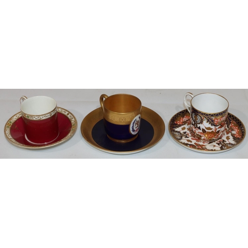 130 - A Royal Worcester coffee can and saucer on royal blue and gilt ground with oval painted crest (sauce... 