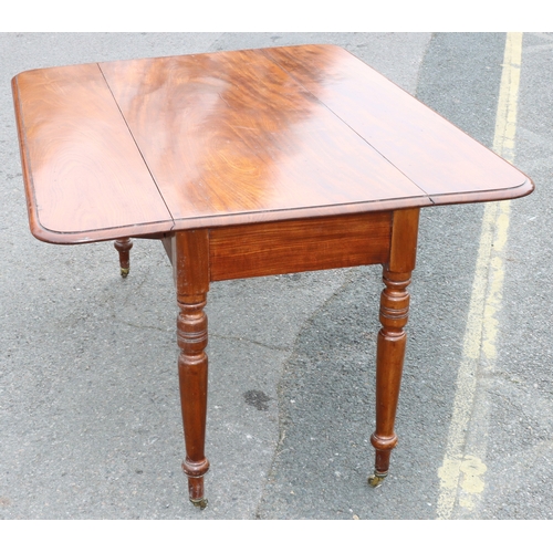 924 - A large 19th Century mahogany Pembroke table with 1 end drawer on round turned legs and brass castor... 