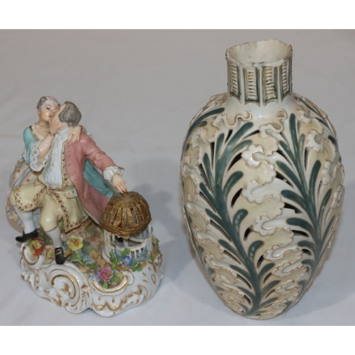 112 - A 19th Century Continental porcelain group of seated gentleman and lady with bird in a cage (gent's ... 