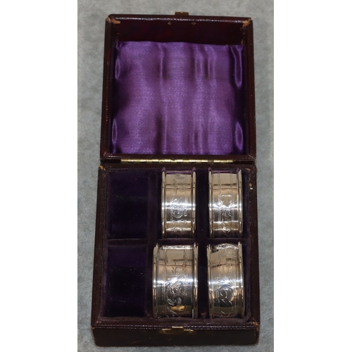 180 - A pair of Birmingham silver round napkin rings and 2 further napkin rings (3), 1oz, with odd leather... 