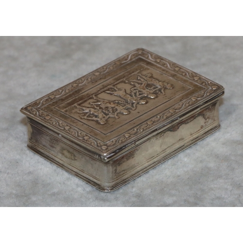 187 - A Continental silver coloured metal rectangular shaped snuff box with hinged lid and embossed figure... 