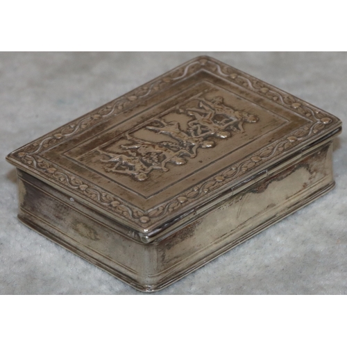 187 - A Continental silver coloured metal rectangular shaped snuff box with hinged lid and embossed figure... 