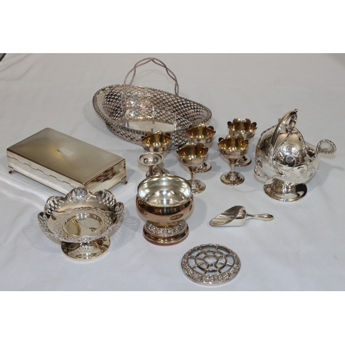 194 - An oval silver plated egg stand with fixed overhead handle mounted with 6 removable egg cups, pierce... 