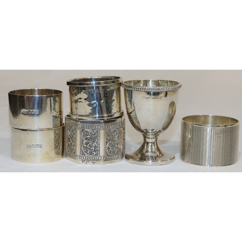 198 - 4 various silver round napkin rings, an Eastern silver coloured metal napkin ring and a Birmingham s... 