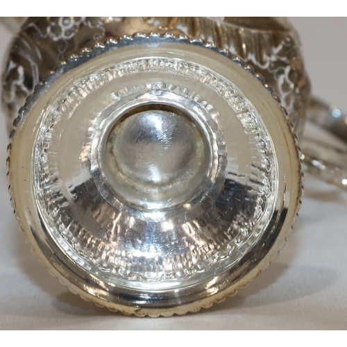 200 - An early George III silver round bulbous shaped milk jug with ball rim and allover embossed bird, fl... 