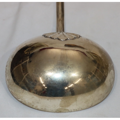 202 - A William IV silver soup ladle with engraved crest, 10.9oz