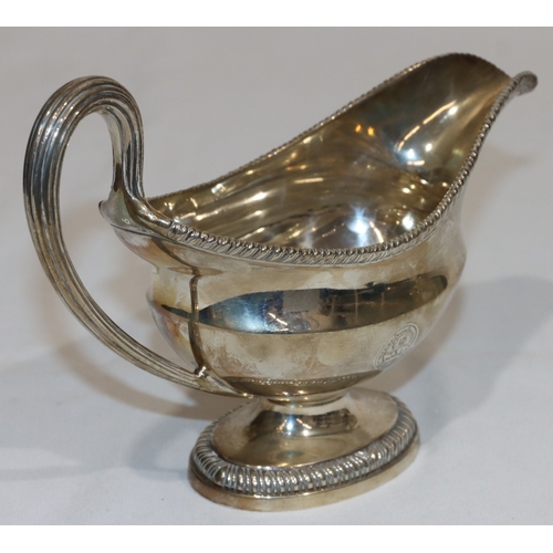 203 - An early George III silver oval sauce boat with gadroon rim, reeded handle, on oval splayed base, en... 