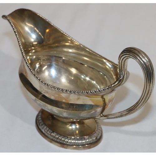 203 - An early George III silver oval sauce boat with gadroon rim, reeded handle, on oval splayed base, en... 