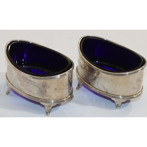 211 - A pair of Chester oval silver salts with blue glass liners, on 4 splayed feet, 8cm wide, 4.4oz