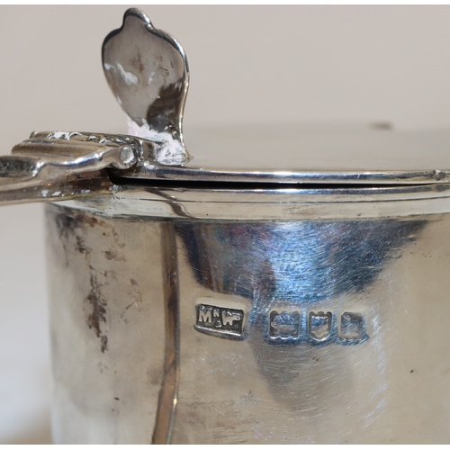 212 - An Edward VII silver round mustard pot with hinged lid enclosing blue glass liner, London 1903, make... 