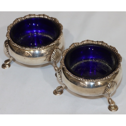 213 - A pair of early George III silver round bulbous shaped salts with crinkle rims with blue glass liner... 