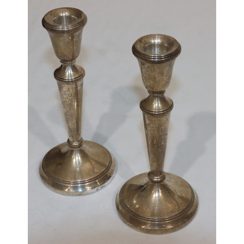 221 - A pair of Birmingham silver candlesticks on turned stems with round sweeping bases, 19cm high (weigh... 