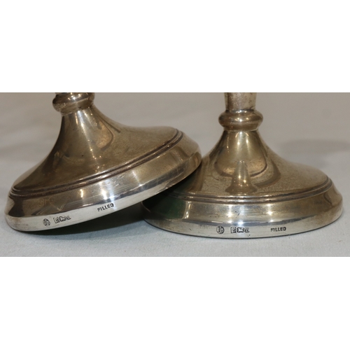 221 - A pair of Birmingham silver candlesticks on turned stems with round sweeping bases, 19cm high (weigh... 