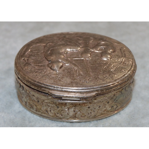 231 - A Continental silver oval snuff box with hinged lid and allover embossed figure, floral and scroll d... 