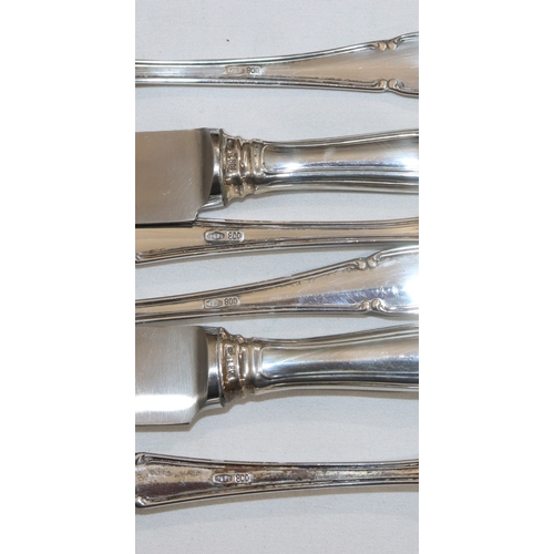 239 - 2 800 silver coloured metal trio matching sets of knife, fork and spoon, both cased, weighable silve... 