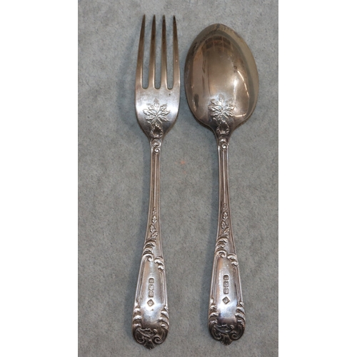 266 - A pair of Sheffield silver child's fork and spoon with raised leaf and scroll decoration, in fitted ... 