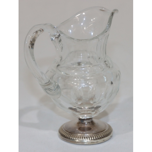 270 - A 19th Century cut glass small round bulbous shaped cream jug with thumb pattern decoration on round... 