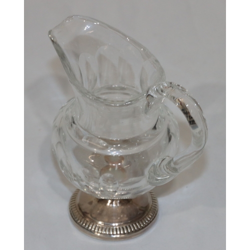 270 - A 19th Century cut glass small round bulbous shaped cream jug with thumb pattern decoration on round... 