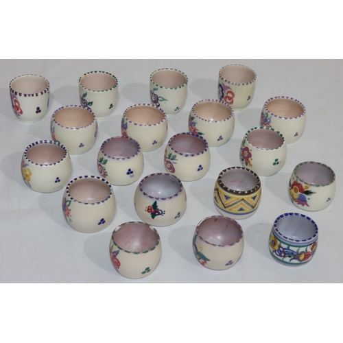 41 - A set of 4 Poole Pottery round bulbous shaped egg cups with multi-coloured floral and leaf decoratio... 