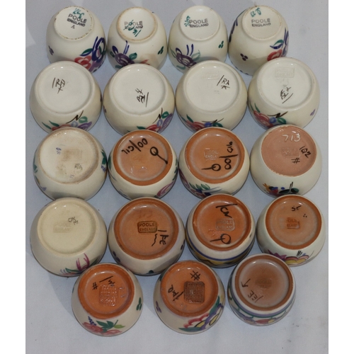 41 - A set of 4 Poole Pottery round bulbous shaped egg cups with multi-coloured floral and leaf decoratio... 