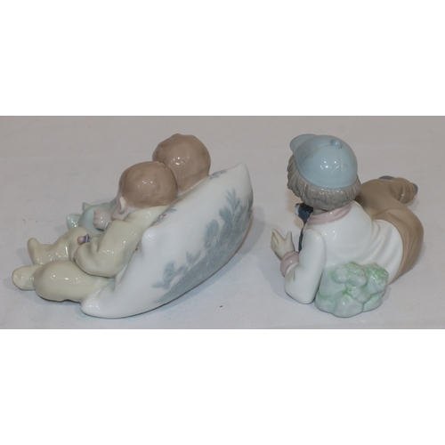 64 - A Lladro group of 2 sleeping babies, 14.5cm wide and a Nao figure of a young boy resting holding a d... 