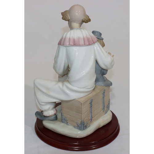 65 - A large Nao group of seated young boy and clown with mahogany circular base (1 finger to clown missi... 