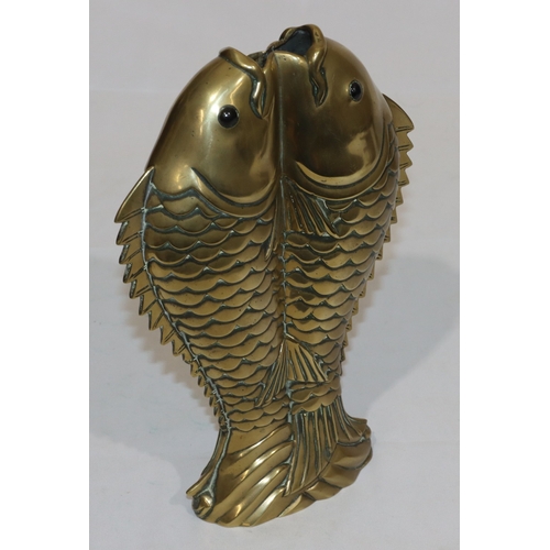 704 - An Oriental heavy brass vase in the form of 2 fish, 28cm high