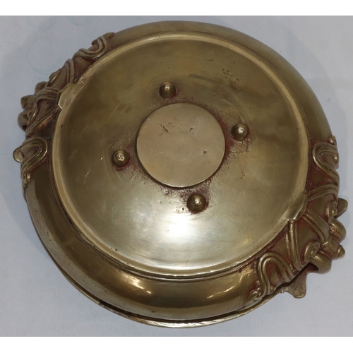 708 - An Oriental gilt bronze round bulbous bowl with raised scroll decoration, 23cm wide