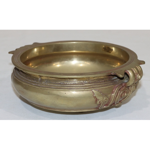 708 - An Oriental gilt bronze round bulbous bowl with raised scroll decoration, 23cm wide