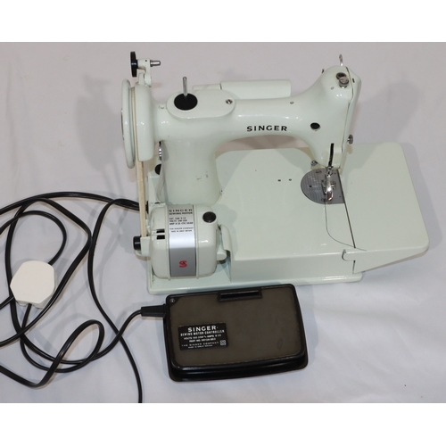 725 - A Singer Featherweight sewing machine, Model 221, on white ground, in pale blue case