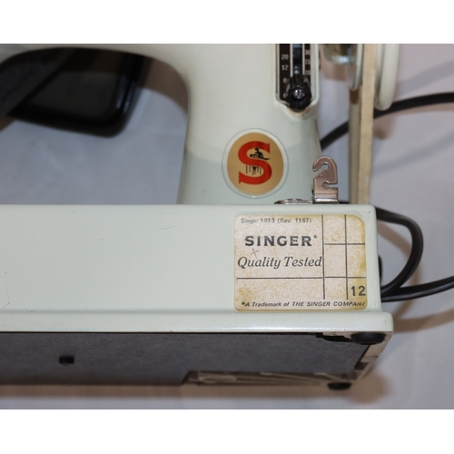 725 - A Singer Featherweight sewing machine, Model 221, on white ground, in pale blue case