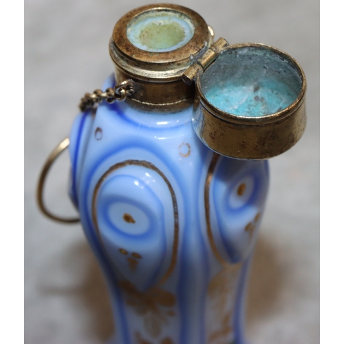 735 - An Opaline and blue pentagon shaped bulbous scent bottle with gilt metal neck and hinged lid, with c... 