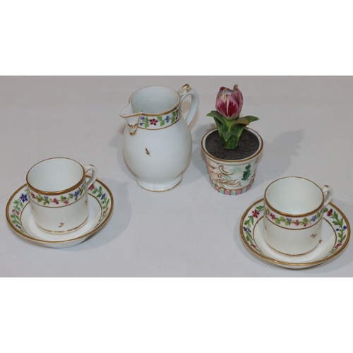 74 - A pair of Continental coffee cups and saucers on white ground with multi-coloured hand painted flora... 